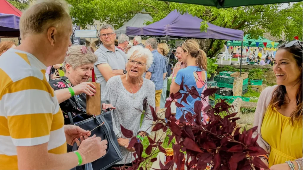 Visitors chatting at a stall in the churchyard