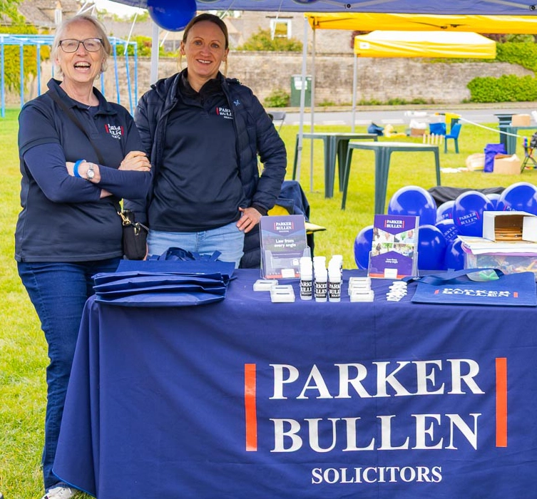 Two people standing behind the Parker Bullen stall at the festival